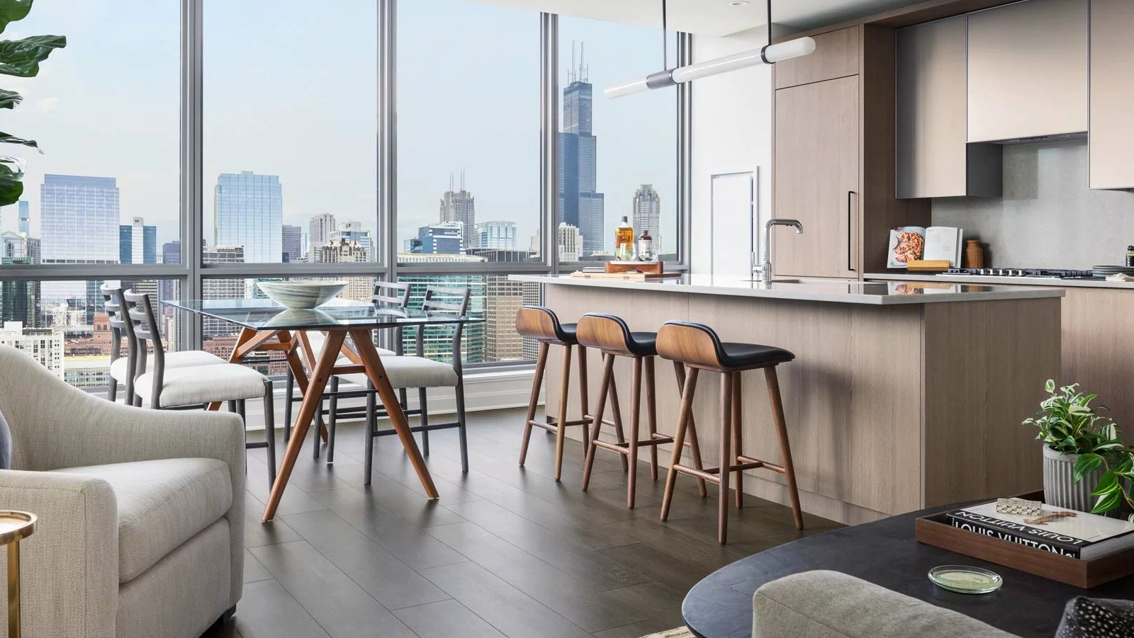 Modern apartment kitchen and dining area at The Row Fulton Market in Chicago, with a large island, stylish seating, and city views