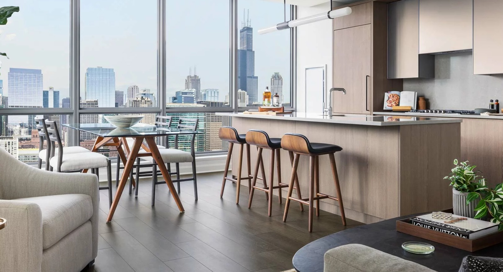 Modern apartment kitchen and dining area at The Row Fulton Market in Chicago, with a large island, stylish seating, and city views