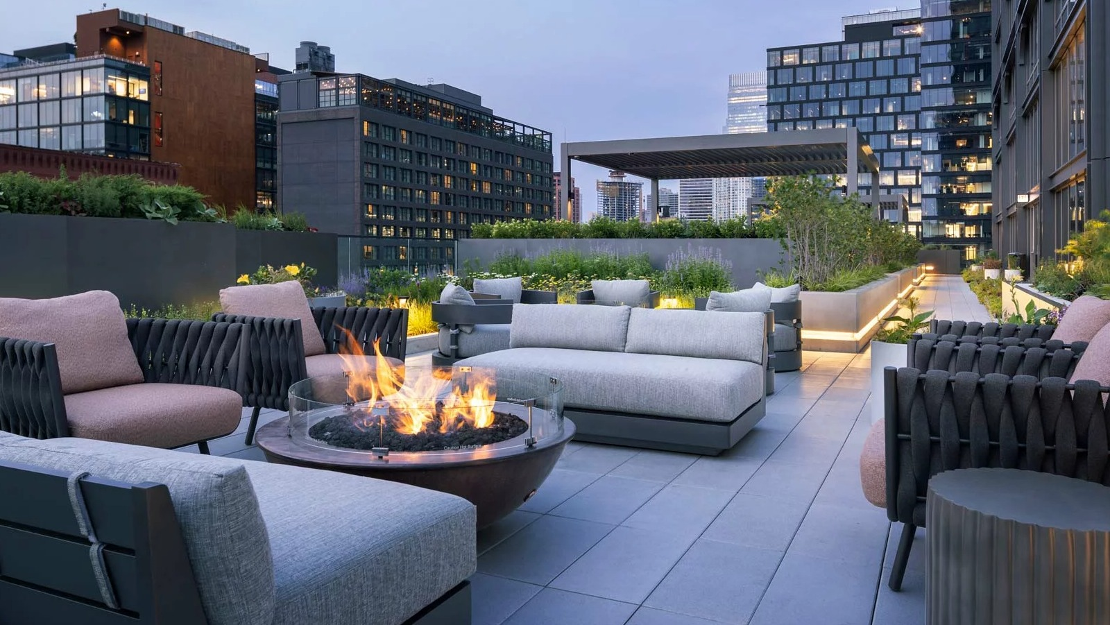 Luxurious rooftop lounge at The Row Fulton Market in Chicago, featuring a modern fire pit, comfortable seating, and city views