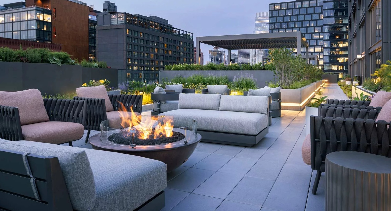 Luxurious rooftop lounge at The Row Fulton Market in Chicago, featuring a modern fire pit, comfortable seating, and city views