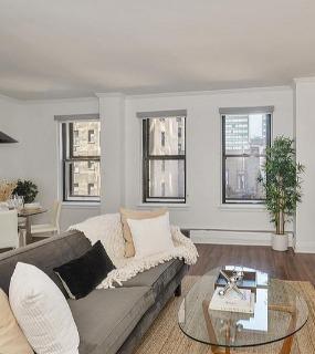 Bright living space with large windows and stylish decor at The Seneca Apartments in Chicago