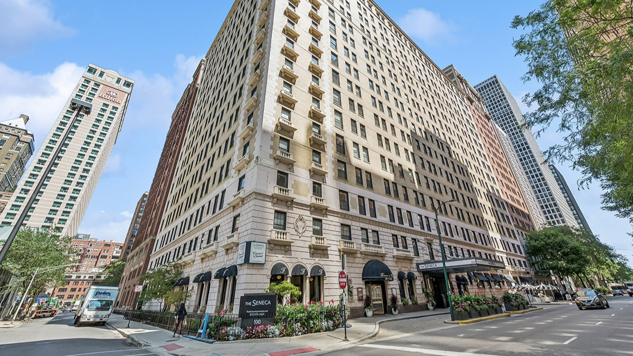Historic exterior of The Seneca Apartments in Chicago, showcasing its classic architecture and prominent street corner location