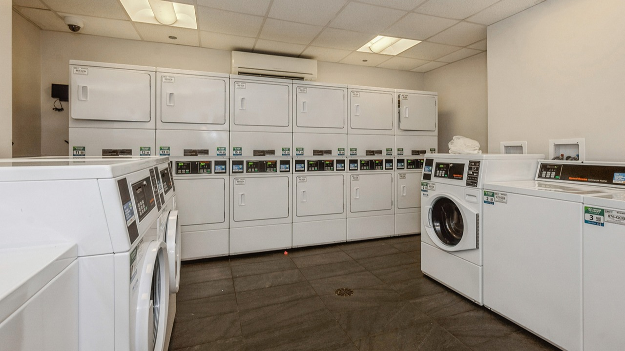 Spacious communal laundry room at The Seneca Apartments in Chicago, featuring multiple washers and dryers for resident convenience
