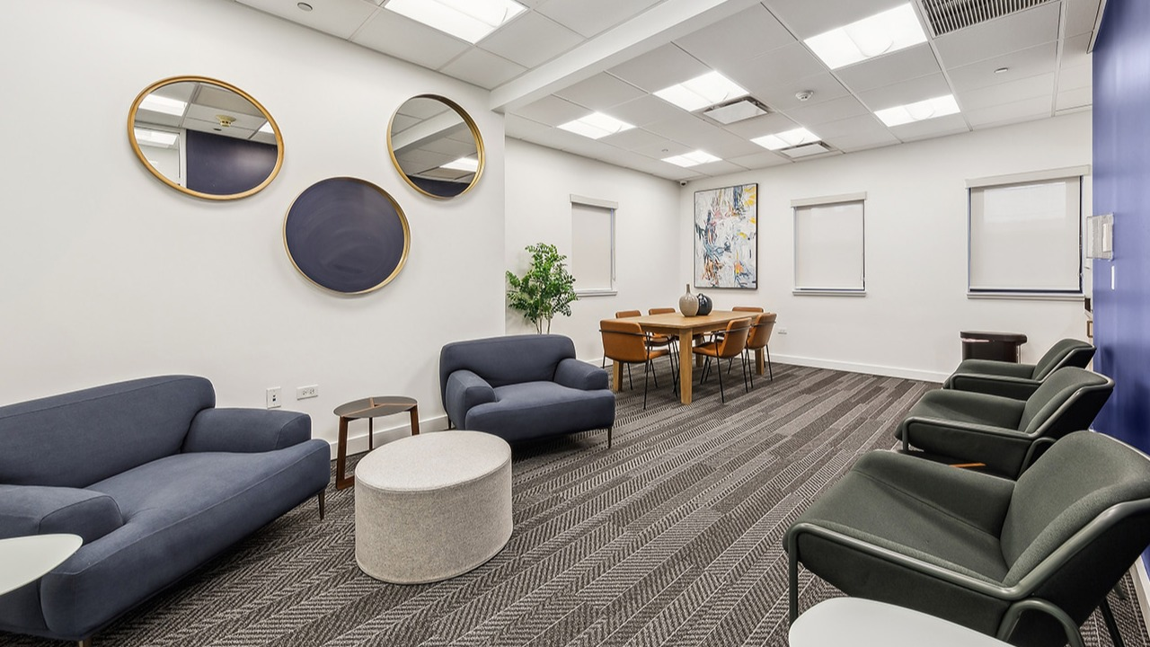 Modern resident lounge at The Seneca Apartments in Chicago, featuring comfortable sofas, armchairs, and a communal dining area