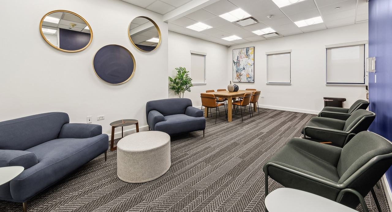 Modern resident lounge at The Seneca Apartments in Chicago, featuring comfortable sofas, armchairs, and a communal dining area