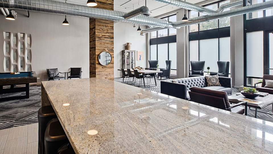 Expansive amenity lounge at The Shelby in Chicago, featuring a large bar, comfortable seating areas, and a pool table