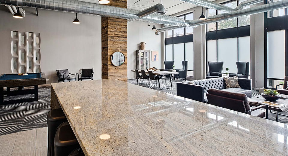 Expansive amenity lounge at The Shelby in Chicago, featuring a large bar, comfortable seating areas, and a pool table