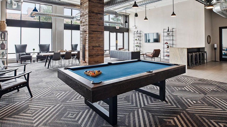Large amenity lounge at The Shelby in Chicago, featuring a pool table, multiple seating areas, and a communal kitchen