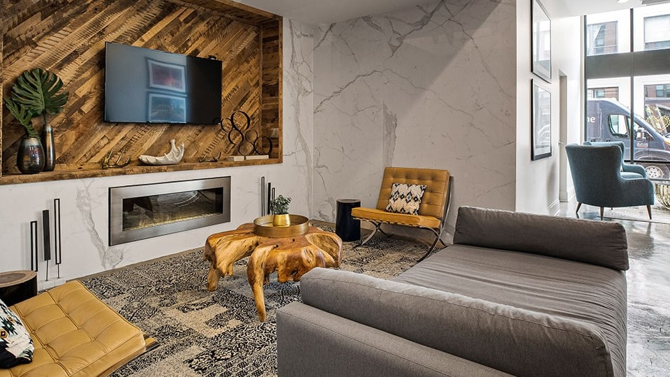 Contemporary resident lounge at The Shelby in Chicago, featuring a modern fireplace, stylish seating, and artistic decor
