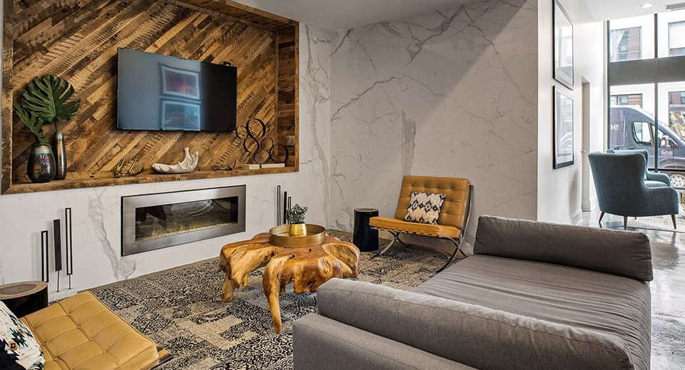 Contemporary resident lounge at The Shelby in Chicago, featuring a modern fireplace, stylish seating, and artistic decor