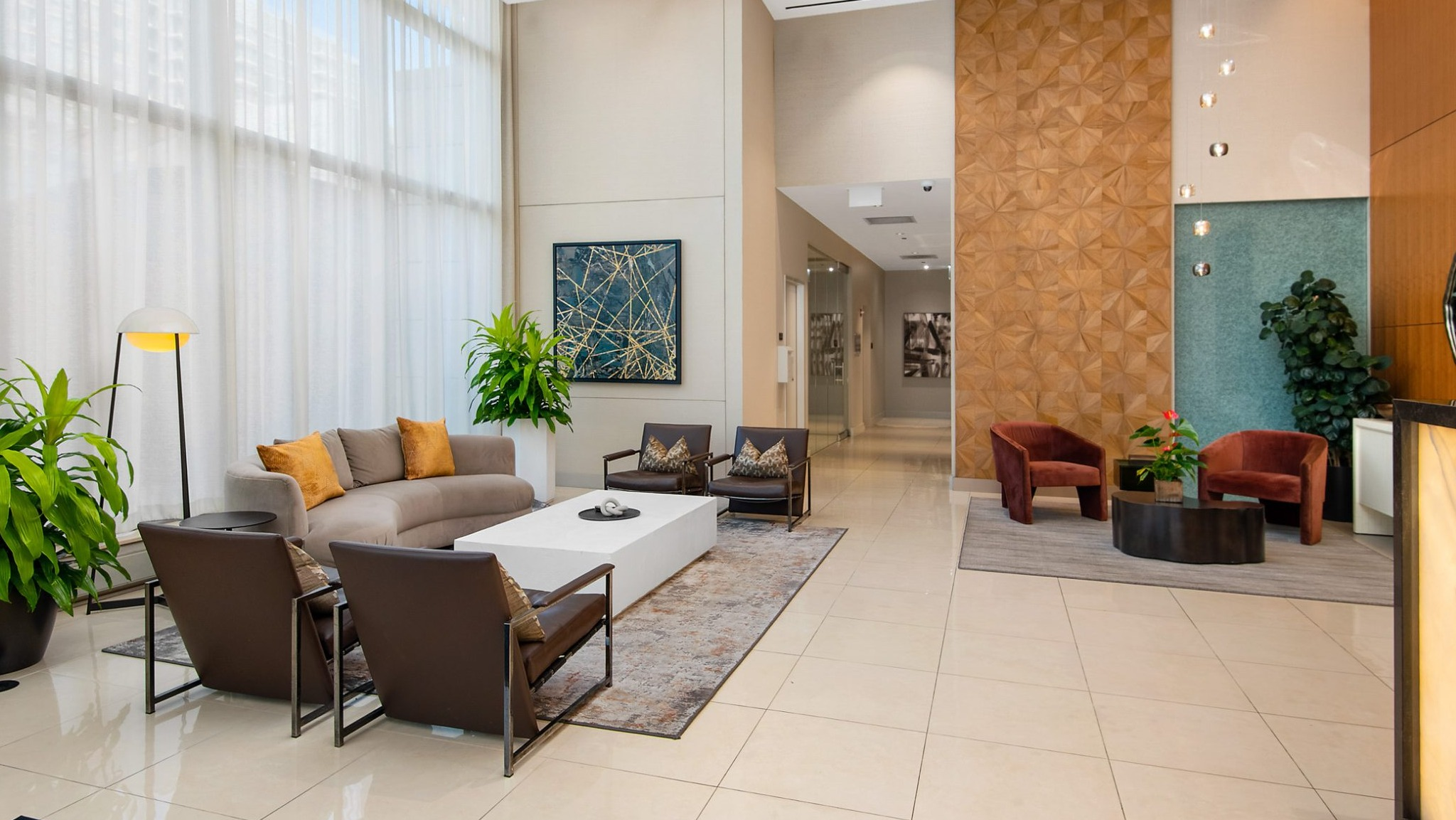 A luxurious and spacious lobby lounge with contemporary furniture, warm lighting, and unique architectural details at The Sinclair in Chicago