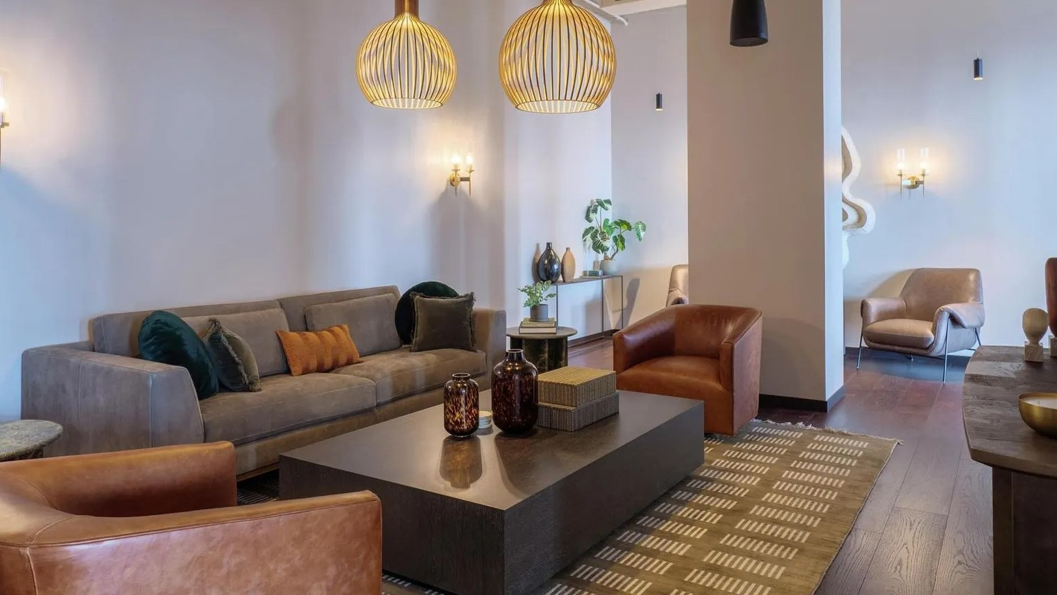 Luxurious resident lounge with plush sofas, leather armchairs, and unique lighting fixtures, perfect for relaxation at The Thompson at Fulton Market in Chicago