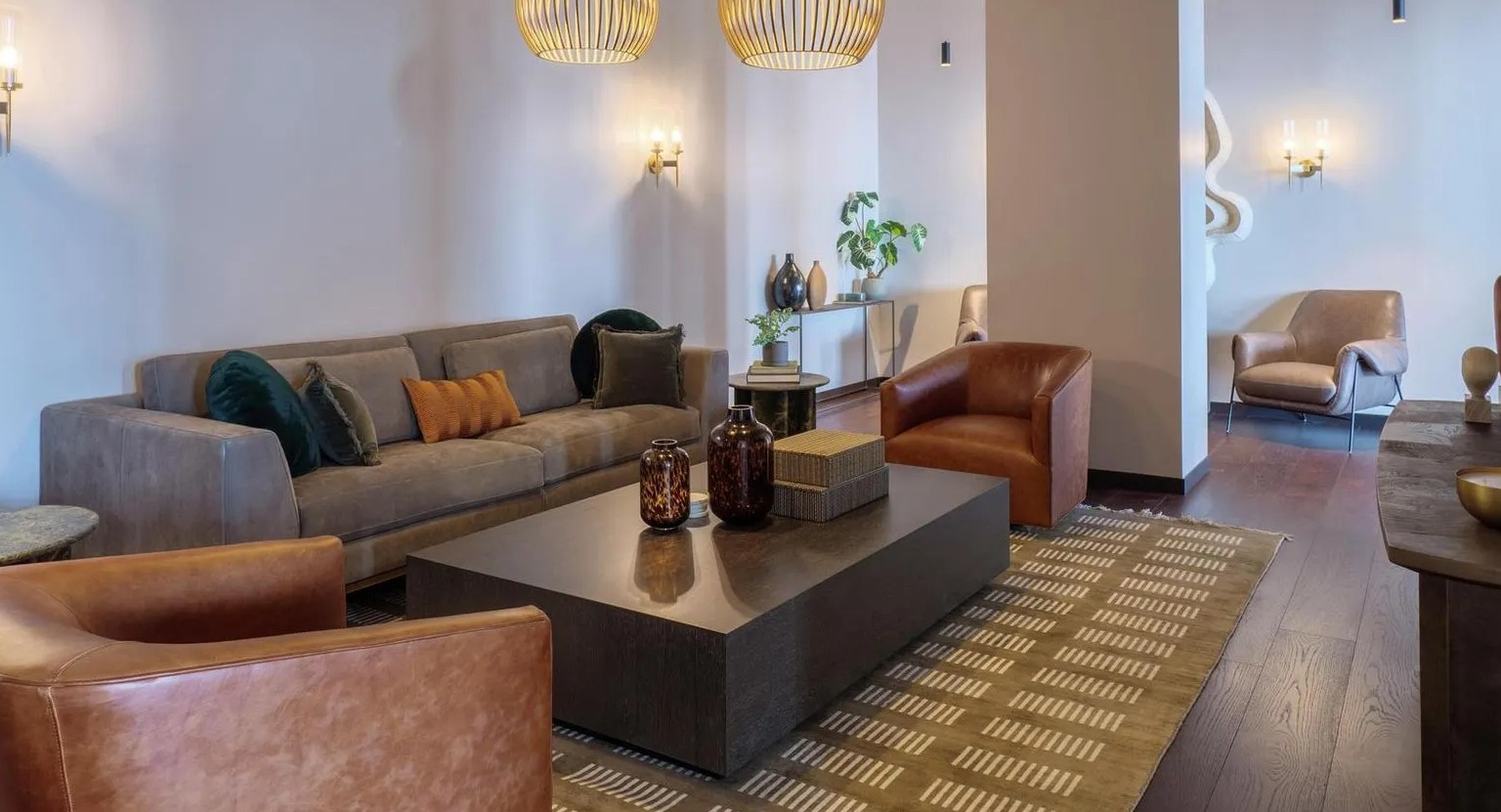 Luxurious resident lounge with plush sofas, leather armchairs, and unique lighting fixtures, perfect for relaxation at The Thompson at Fulton Market in Chicago
