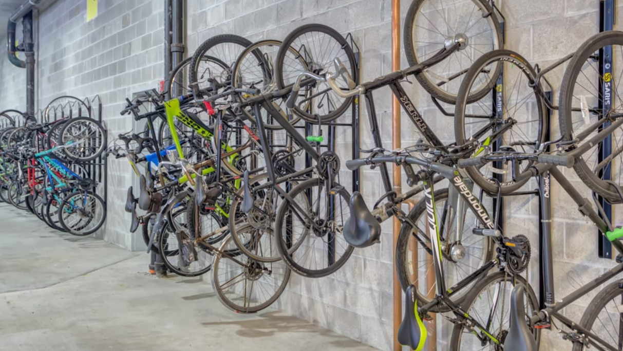 Secure and organized bike storage area with multiple hanging racks for residents at The Van Buren apartments in Chicago