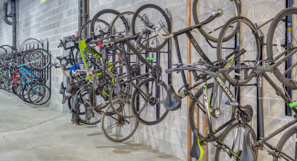 Secure and organized bike storage area with multiple hanging racks for residents at The Van Buren apartments in Chicago