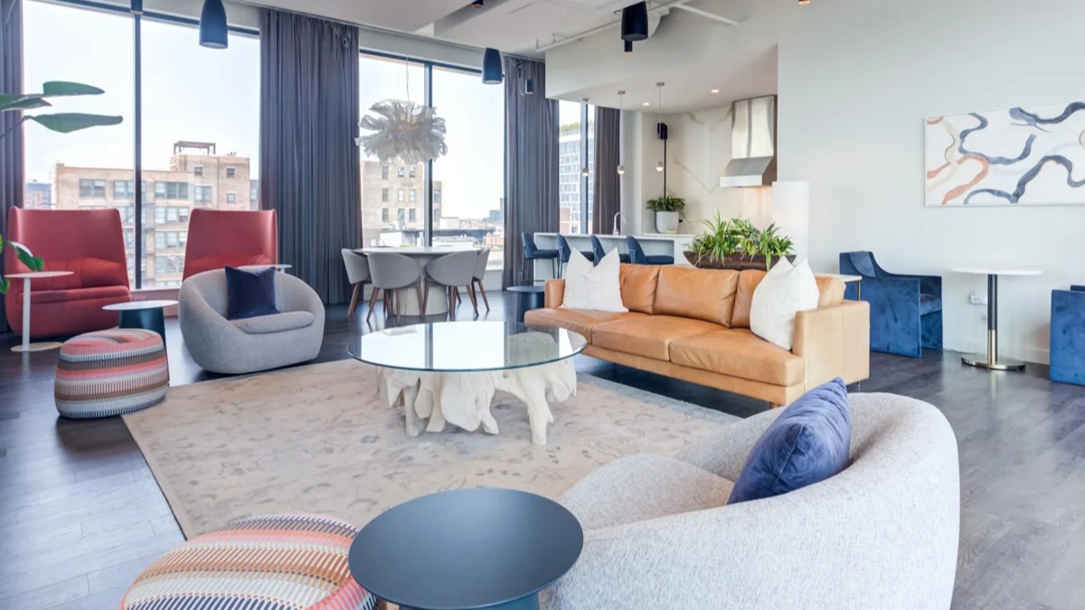 Spacious clubroom at The Van Buren apartments, designed for socializing with various seating areas and modern decor in Chicago