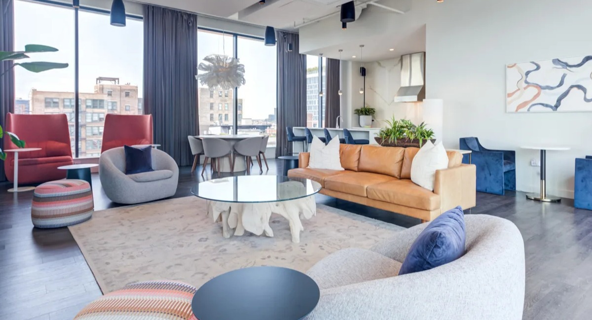 Spacious clubroom at The Van Buren apartments, designed for socializing with various seating areas and modern decor in Chicago