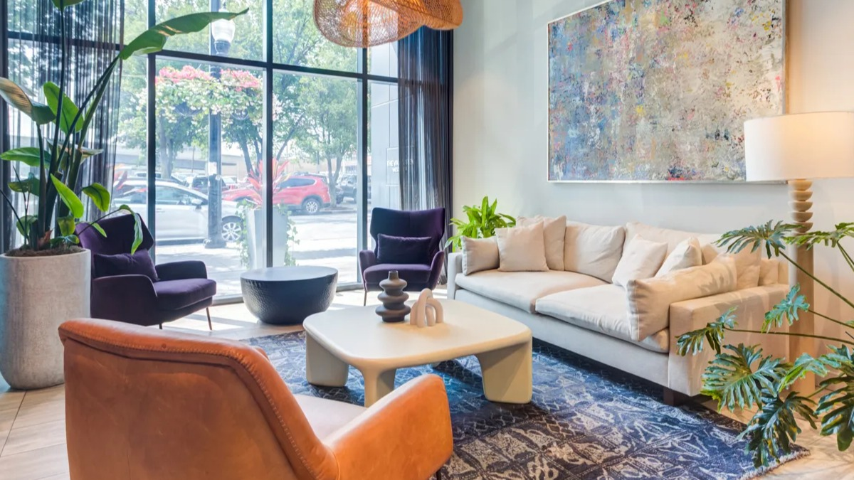 Inviting resident lounge at The Van Buren in Chicago, featuring comfortable seating, large windows, and contemporary decor