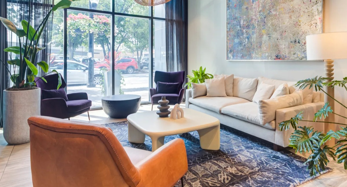 Inviting resident lounge at The Van Buren in Chicago, featuring comfortable seating, large windows, and contemporary decor