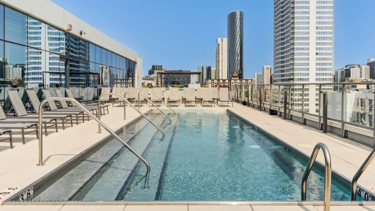 Beautiful rooftop swimming pool at The Van Buren apartments in Chicago, with ample space for lounging and city skyline views