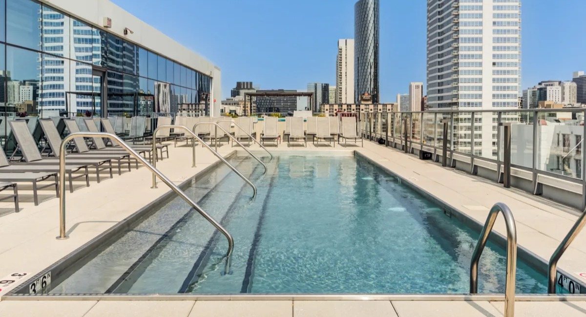 Beautiful rooftop swimming pool at The Van Buren apartments in Chicago, with ample space for lounging and city skyline views