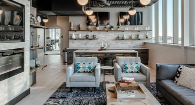 Stylish resident lounge at Trio Apartments in Chicago, featuring a cozy fireplace, comfortable seating, and modern decor