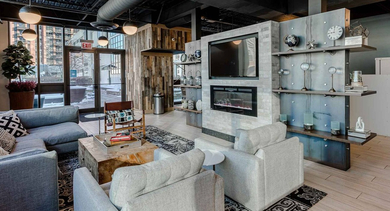 Modern resident lounge and lobby area at Trio Apartments in Chicago, offering comfortable seating and a warm, inviting atmosphere