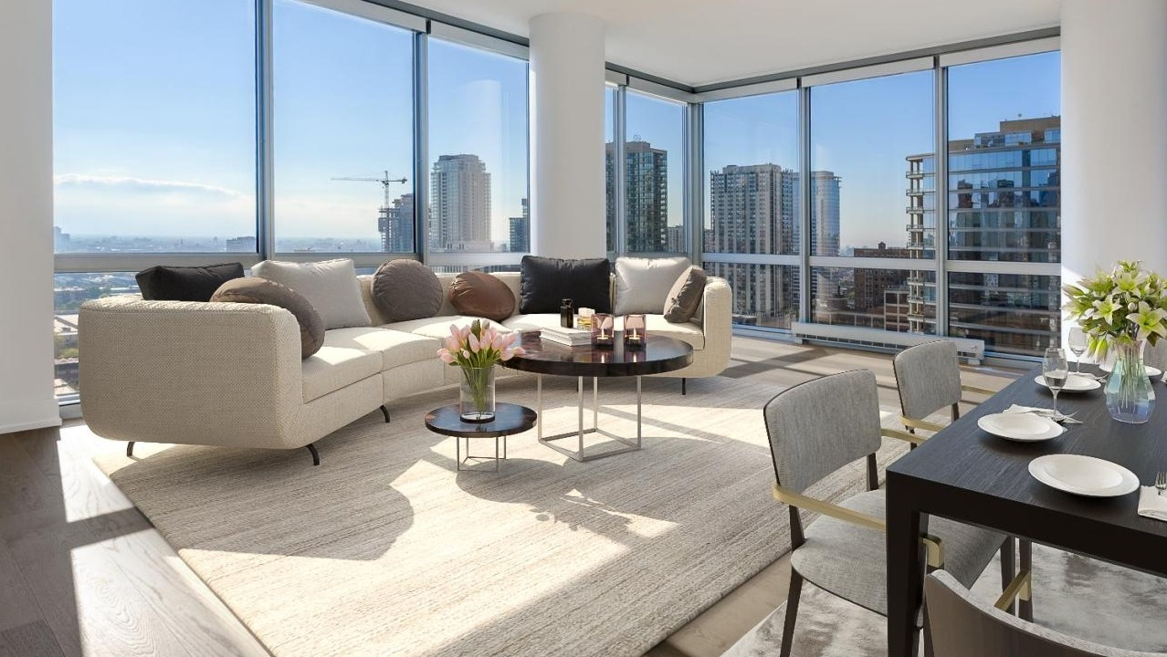 Spacious apartment interior with light-filled rooms, contemporary furnishings, and panoramic city views at Two West in Chicago