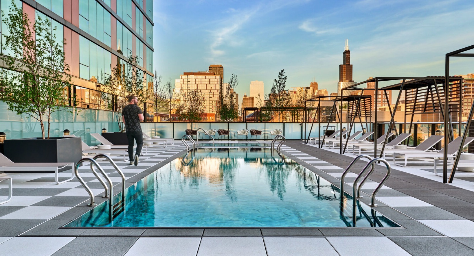 Stunning rooftop pool at Fulbrix Apartments in Chicago, offering breathtaking city skyline views and a luxurious atmosphere