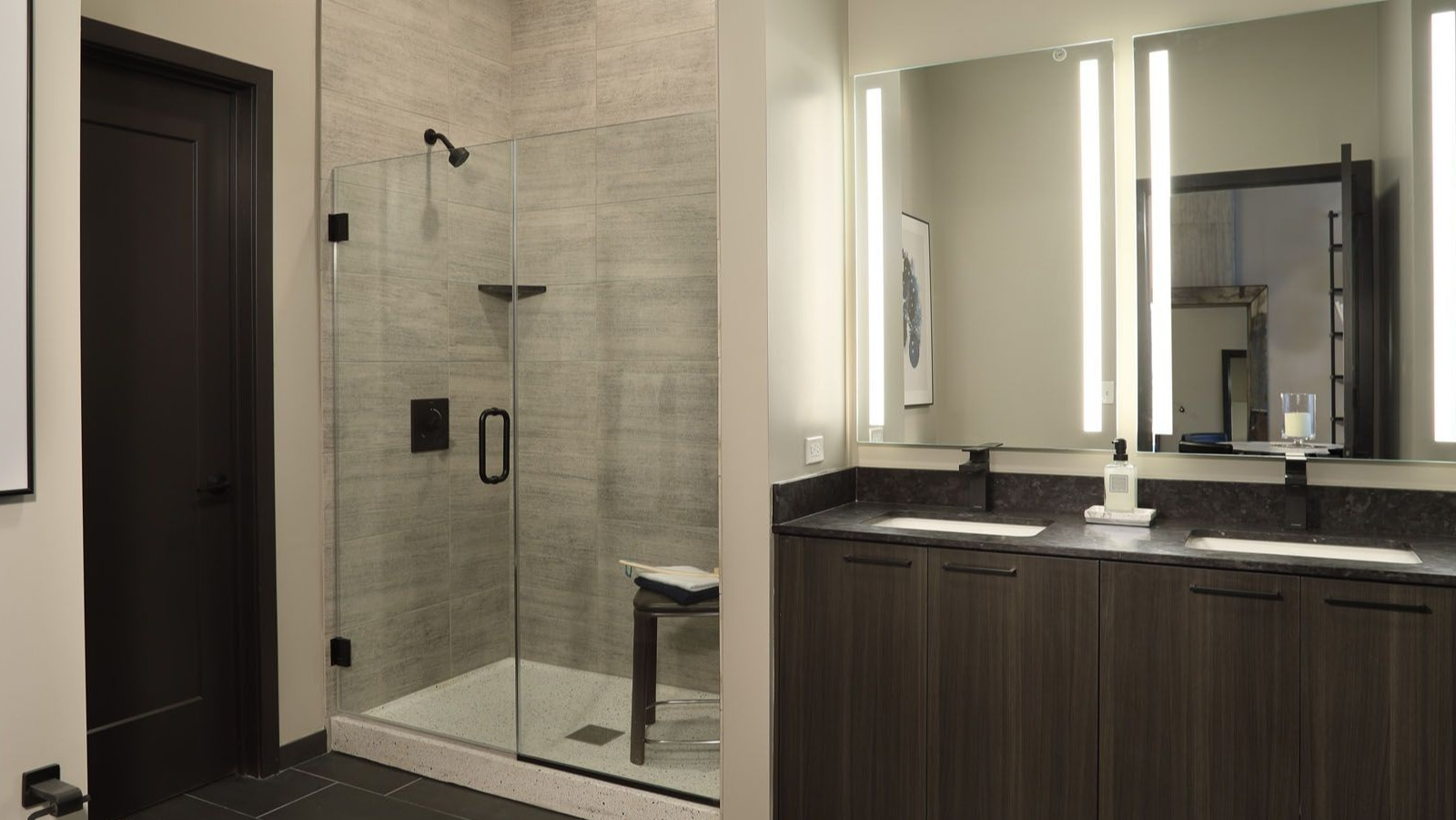 Sleek bathroom with a spacious walk-in shower, double vanity, and contemporary fixtures at Union West, Chicago