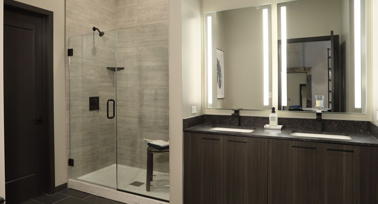 Sleek bathroom with a spacious walk-in shower, double vanity, and contemporary fixtures at Union West, Chicago