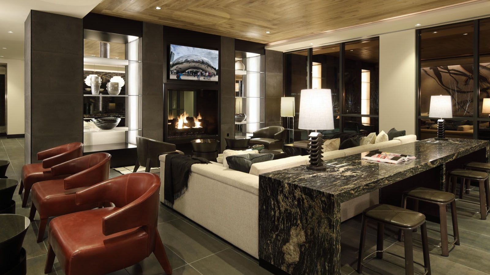 Elegant communal space with a cozy fireplace, high-top seating, and comfortable lounge furniture at Union West, Chicago