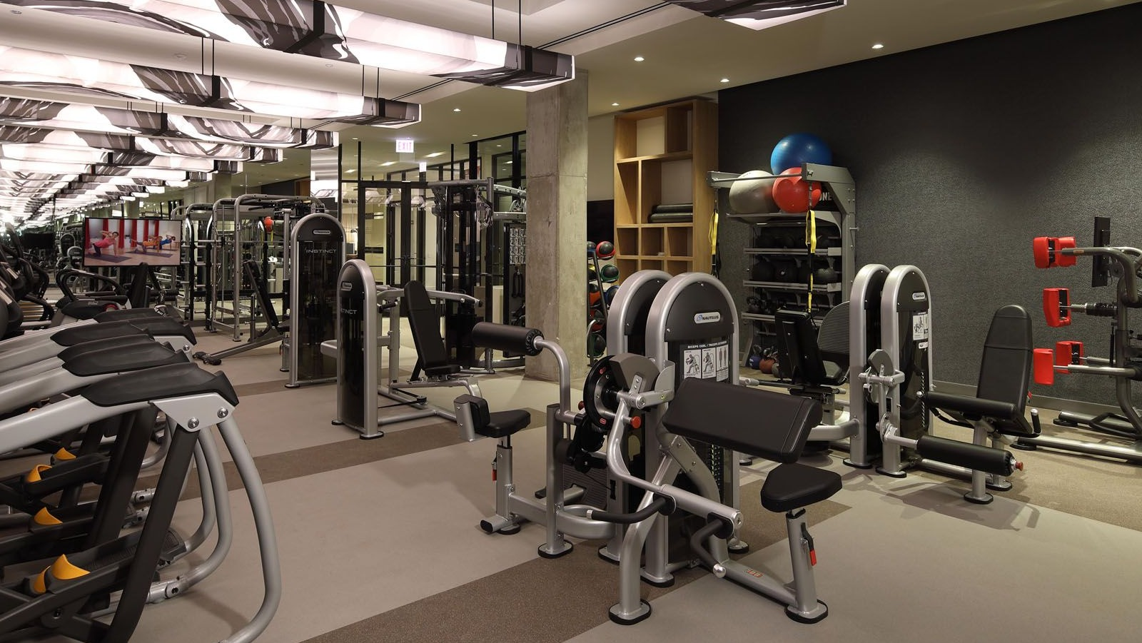 Comprehensive fitness center equipped with various strength training and cardio machines for residents at Union West, Chicago