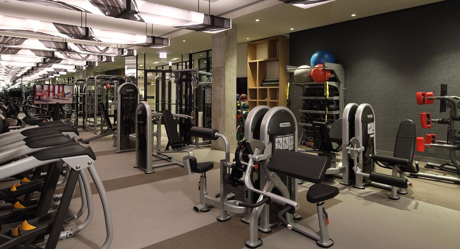 Comprehensive fitness center equipped with various strength training and cardio machines for residents at Union West, Chicago