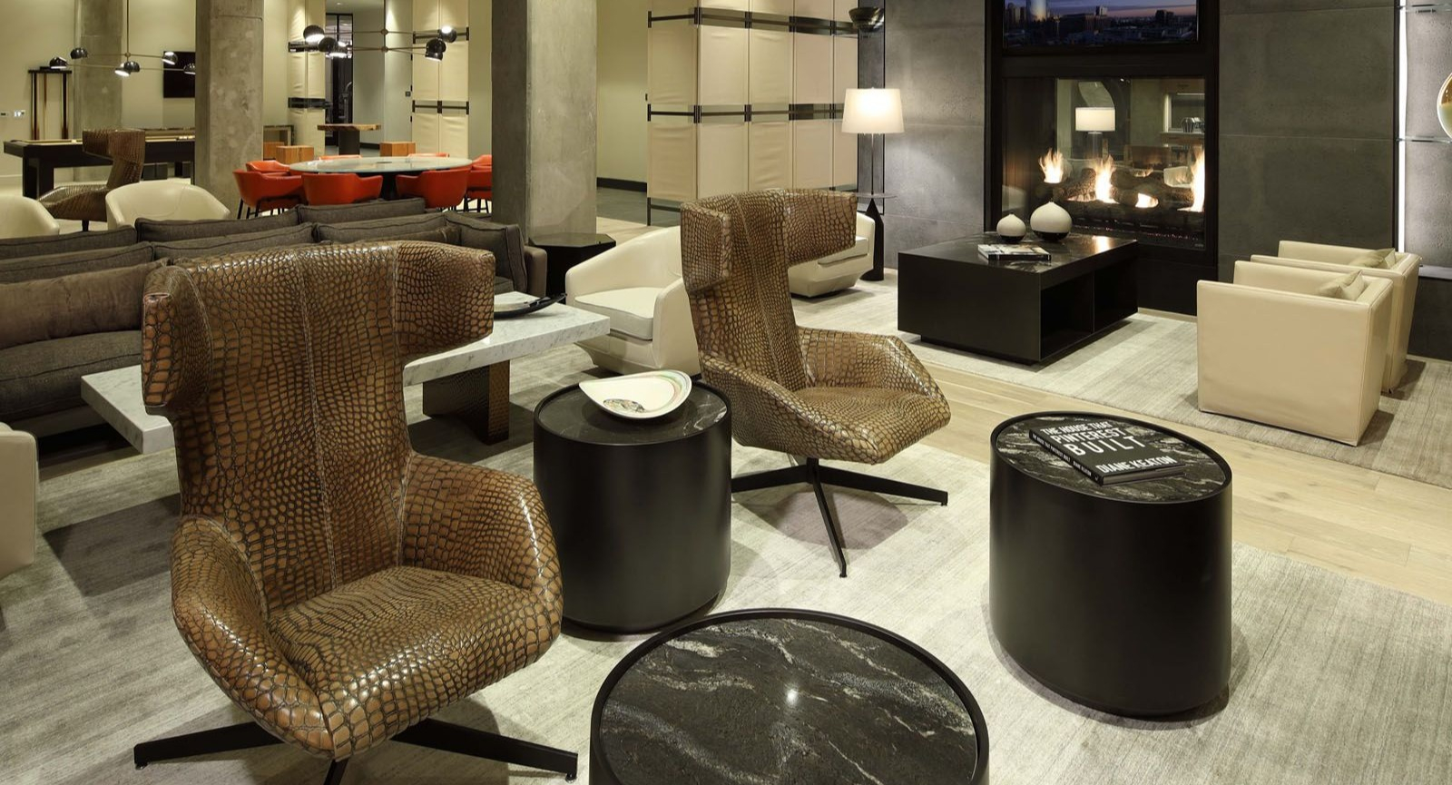 Luxurious resident lounge with a modern fireplace, stylish armchairs, and comfortable sofas at Union West, Chicago