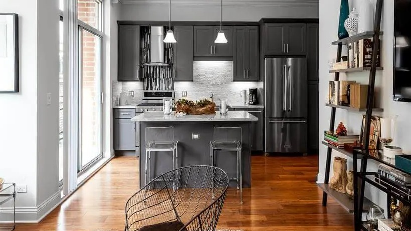 Bright apartment showing the seamless connection between a modern kitchen and a stylish living room at Wells Place, Chicago