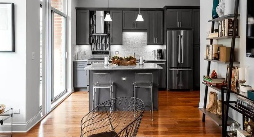 Bright apartment showing the seamless connection between a modern kitchen and a stylish living room at Wells Place, Chicago
