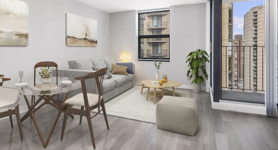 Spacious living and dining room with a comfortable sofa, elegant decor, and a balcony with city views at West77 Apartments in Chicago