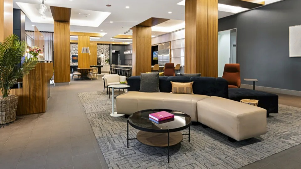 Elegant lobby lounge with stylish furniture, warm wood accents, and a welcoming atmosphere at West77 Apartments in Chicago