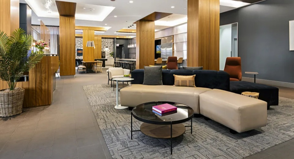 Elegant lobby lounge with stylish furniture, warm wood accents, and a welcoming atmosphere at West77 Apartments in Chicago