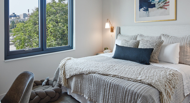 Bright bedroom with neutral decor, large window, and a comfortable pet bed, ideal for residents and their pets at Westerly, Chicago