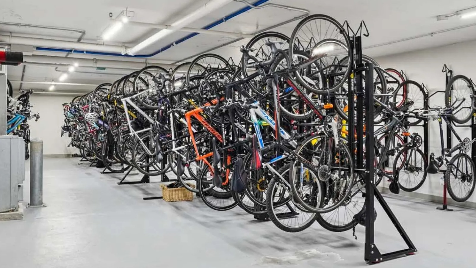 Secure and spacious bike storage room with multiple racks and a repair station at Wolf Point East apartments in Chicago