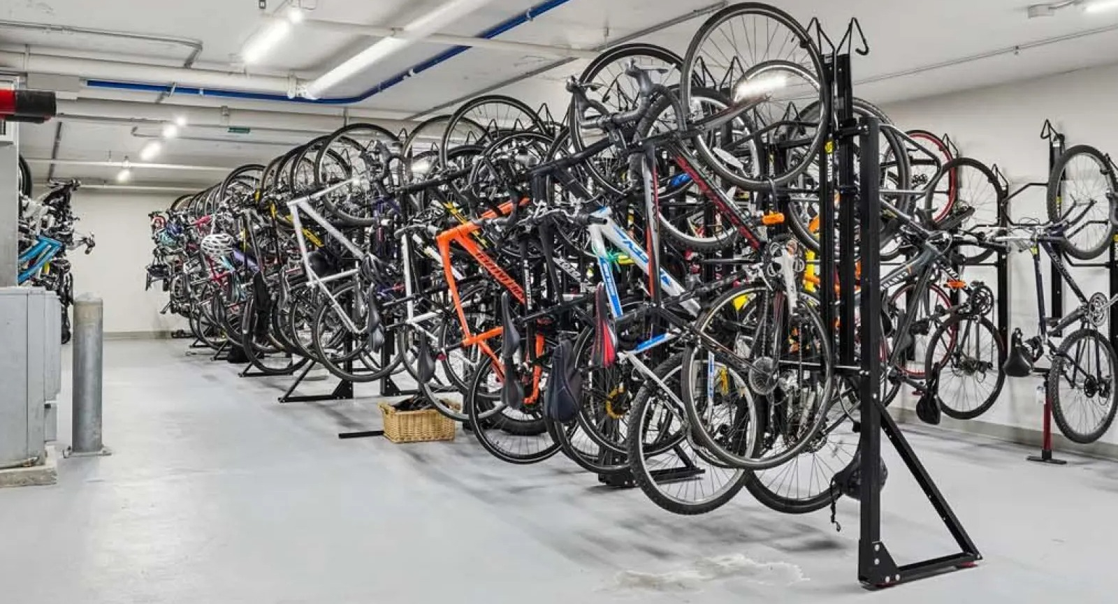 Secure and spacious bike storage room with multiple racks and a repair station at Wolf Point East apartments in Chicago