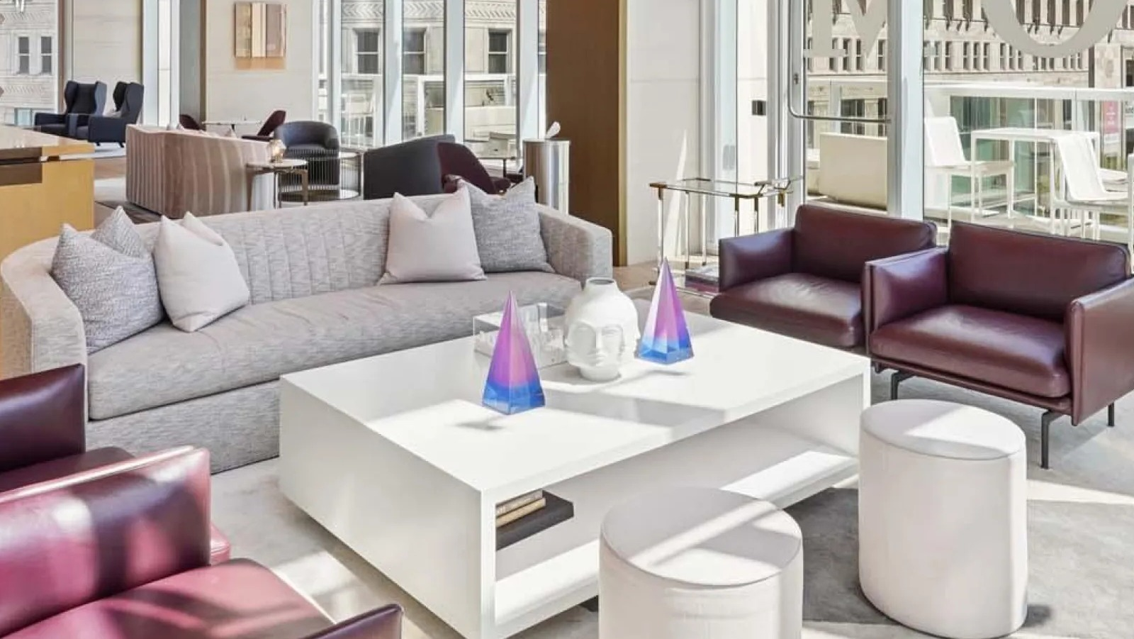 Elegant lobby lounge area with sophisticated seating, high ceilings, and expansive city views at Wolf Point East apartments in Chicago