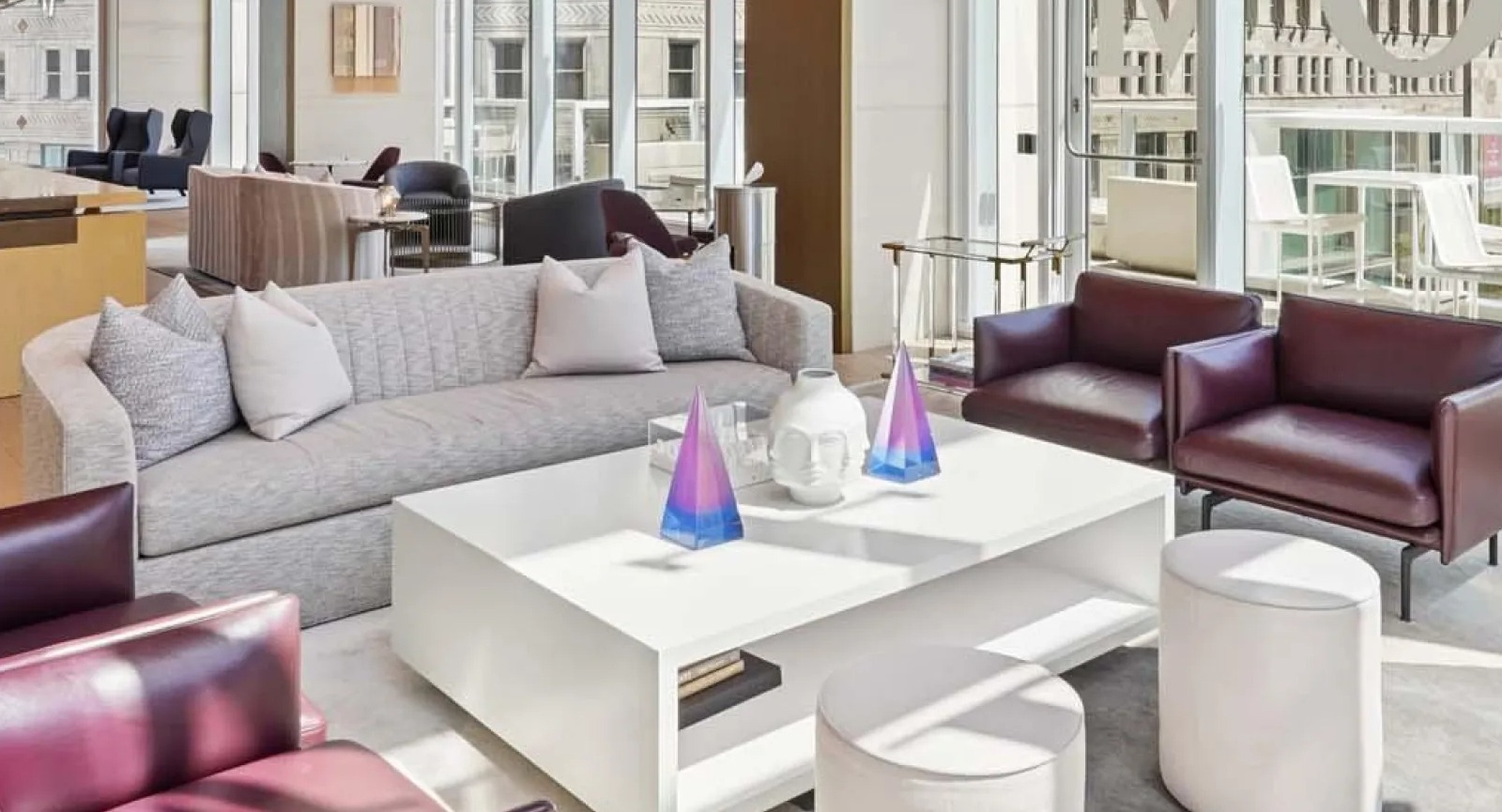 Elegant lobby lounge area with sophisticated seating, high ceilings, and expansive city views at Wolf Point East apartments in Chicago