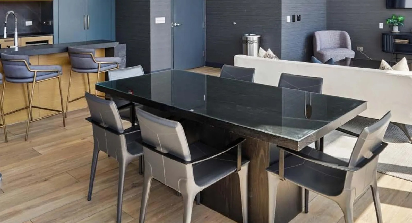 Chic resident lounge and communal kitchen with modern appliances and a large dining table at Wolf Point East in Chicago