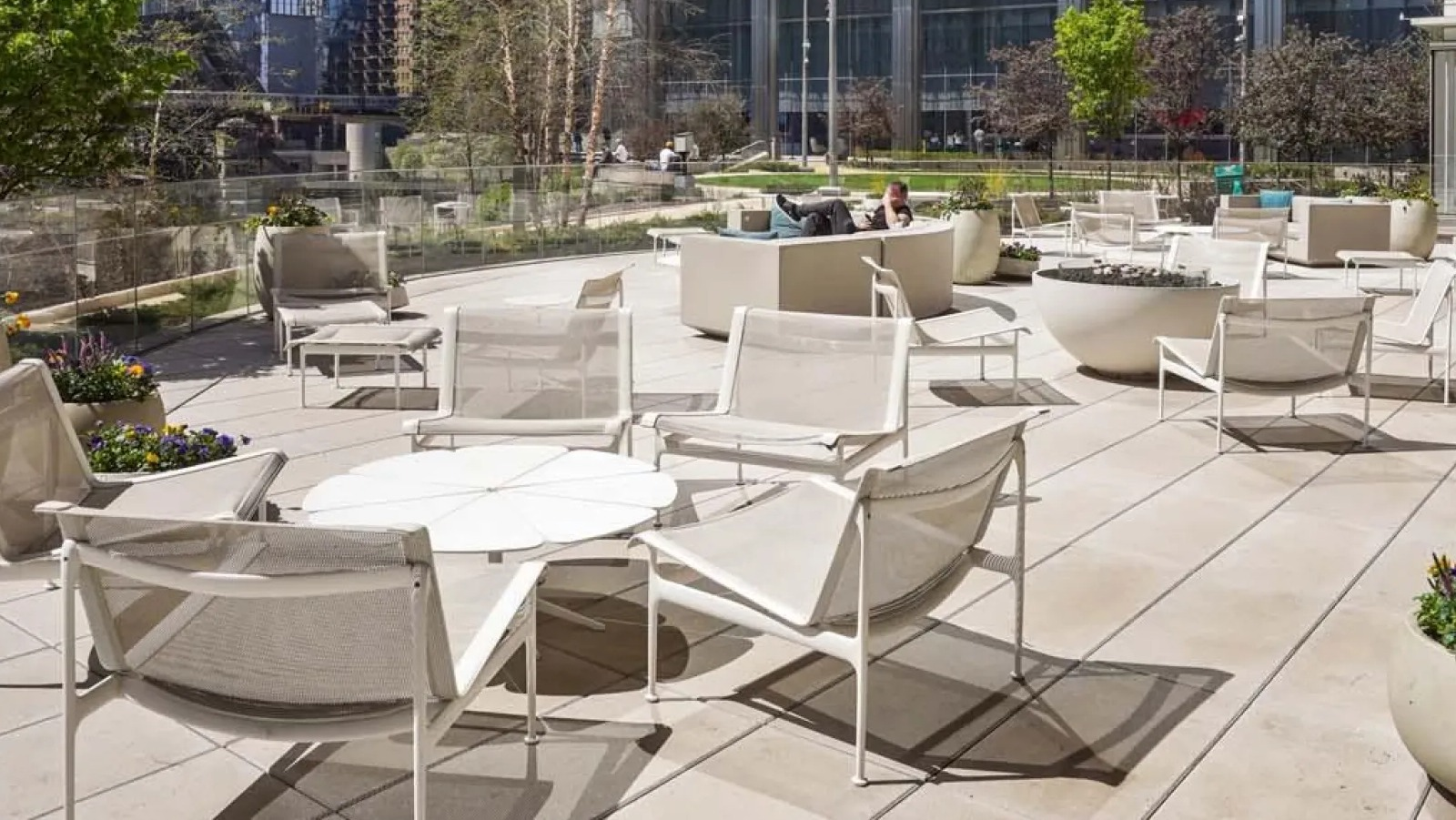 Expansive rooftop deck with various lounge seating arrangements and stunning city skyscraper views at Wolf Point East in Chicago