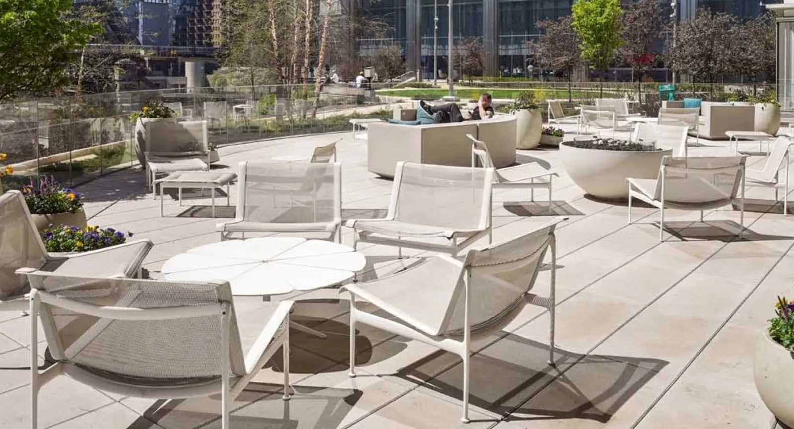 Expansive rooftop deck with various lounge seating arrangements and stunning city skyscraper views at Wolf Point East in Chicago