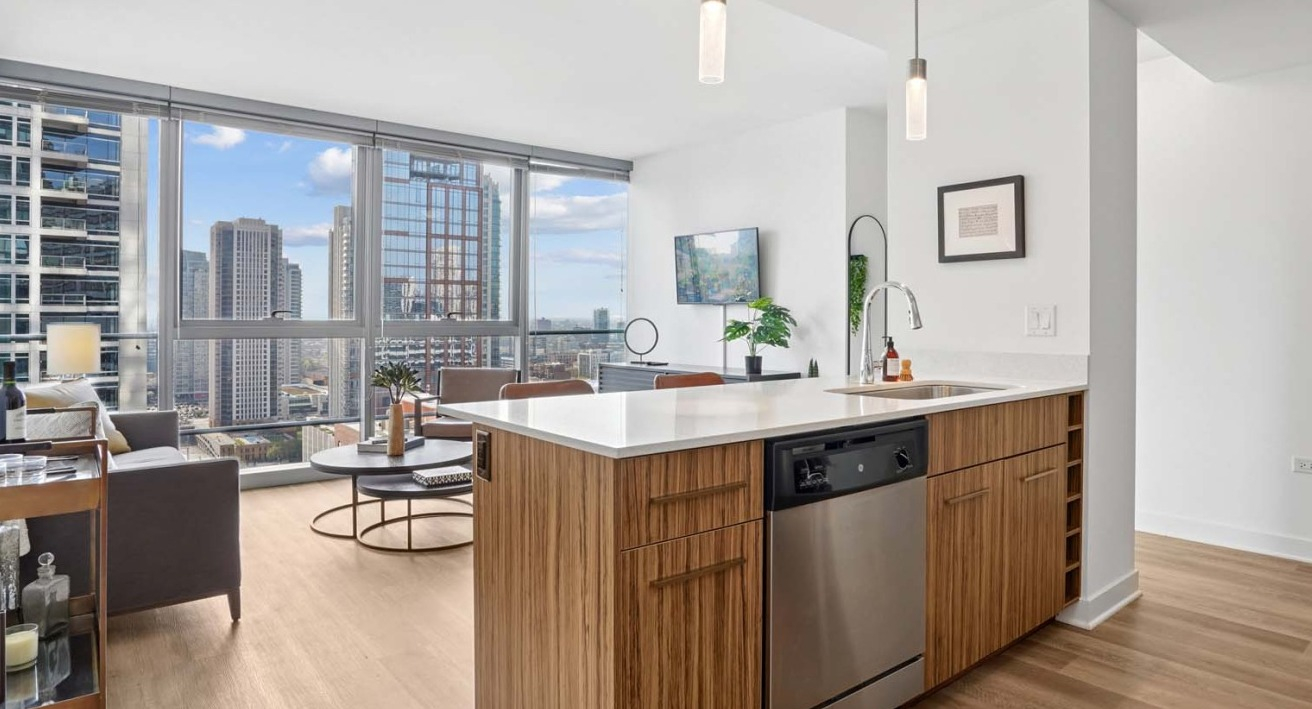 Spacious living room at Wolf Point West apartments in Chicago with floor-to-ceiling windows and city skyline views