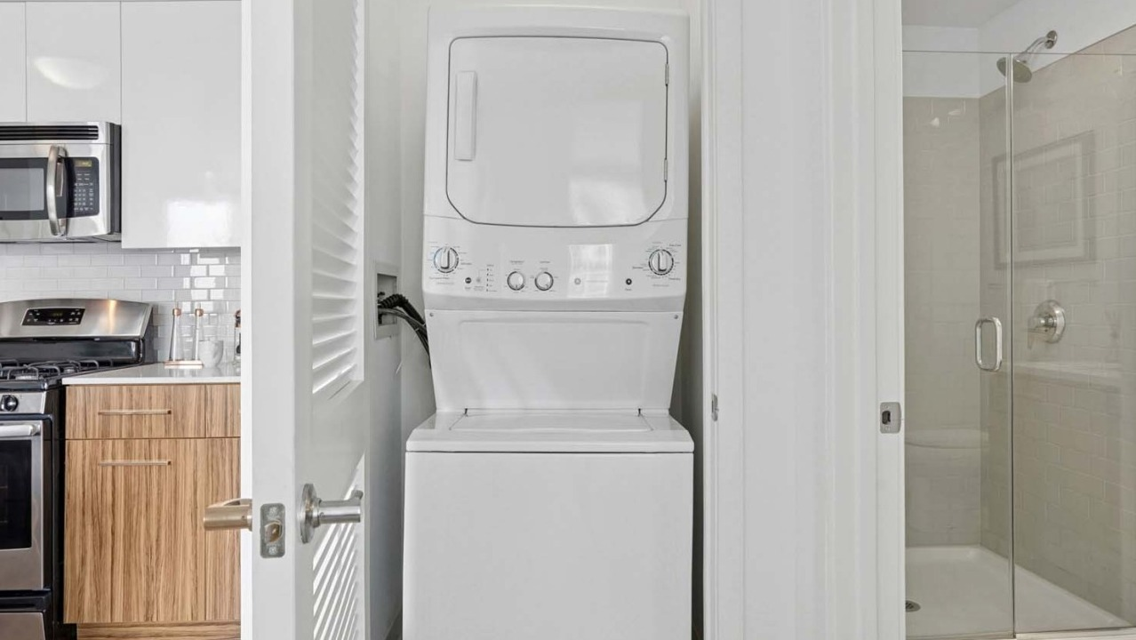 In-unit washer and dryer inside Wolf Point West apartments in Chicago with modern finishes and easy access